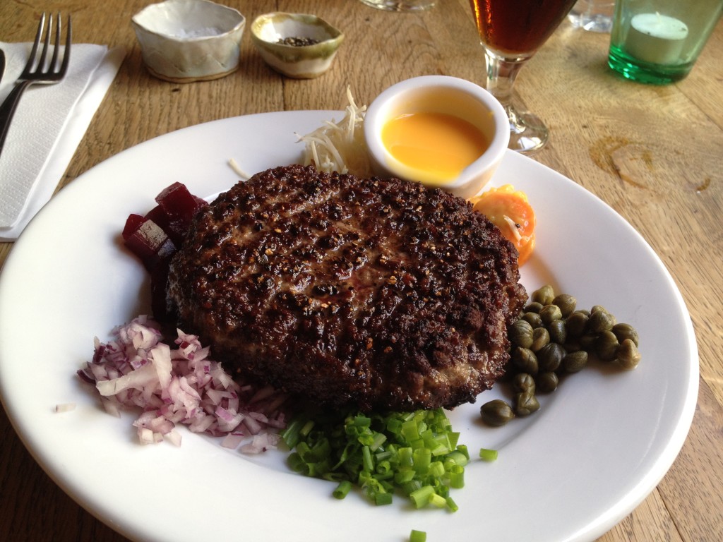 Paris beef with fresh veggies and raw egg yolk at Rabes have in Copenhagen